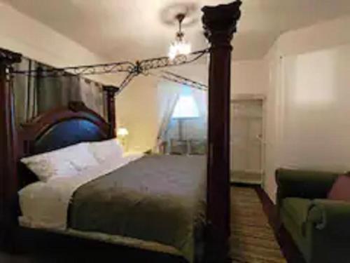 a bedroom with a canopy bed and a couch at Easy UW, Downtown Access in Seattle