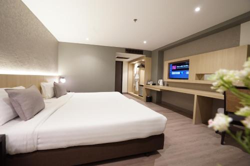Ένα ή περισσότερα κρεβάτια σε δωμάτιο στο King Park Avenue Hotel Bangkok