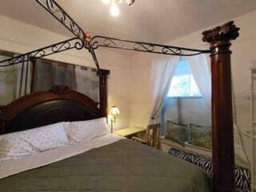 a bedroom with a canopy bed with a window at Easy UW, Downtown Access in Seattle
