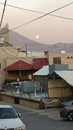 a street with cars parked in front of a building at in the heart of Majdal-shams in Majdal Shams