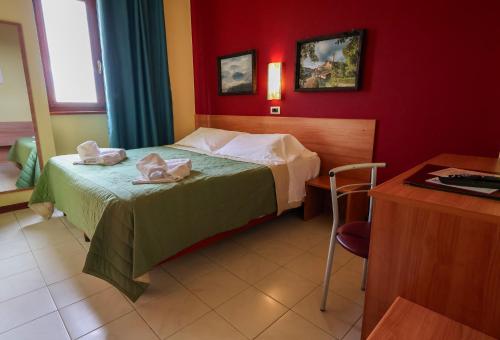 a hotel room with a bed with towels on it at Hotel Erbaluce in Caluso