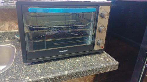 a toaster oven sitting on top of a counter at أهلا بكم in Luxor