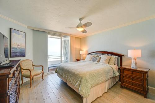 a bedroom with a bed and a desk and a window at Oceanfront Marco Island Escape with Beach Access! in Marco Island