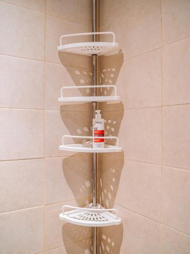 a shelf in a bathroom with white dishes on it at Tamraght Bleu House in Tamraght Oufella