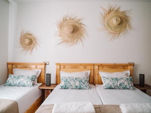 two beds in a room with two at Tamraght Bleu House in Tamraght Oufella