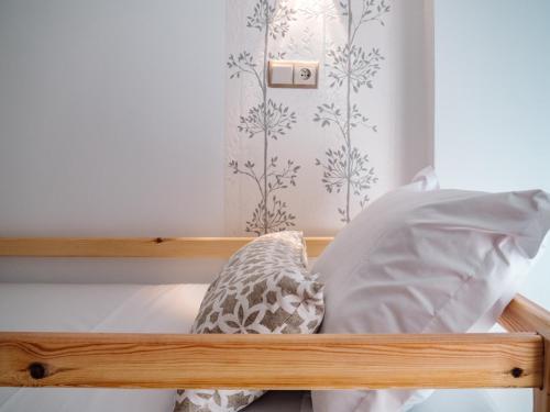 a bed with white sheets and pillows on it at Tamraght Bleu House in Tamraght Oufella