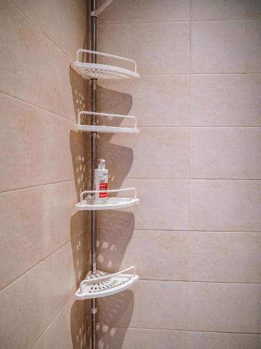 a towel rack in a bathroom with white plates at Tamraght Bleu House in Tamraght Oufella