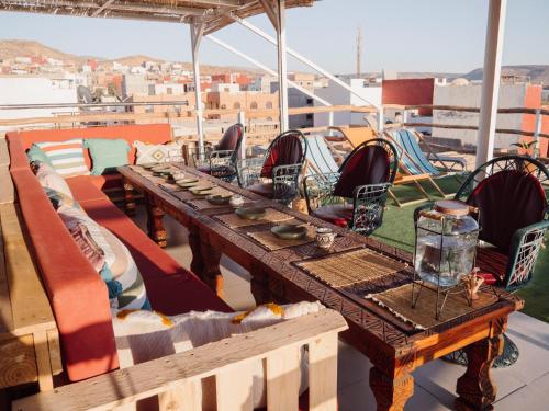 a table on top of a boat with chairs at Tamraght Bleu House in Tamraght Oufella