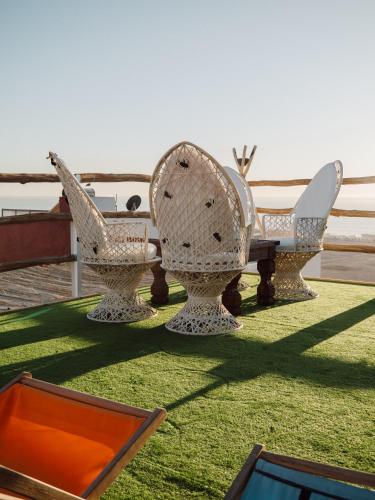 a group of chairs sitting on top of a lawn at Tamraght Bleu House in Tamraght Oufella