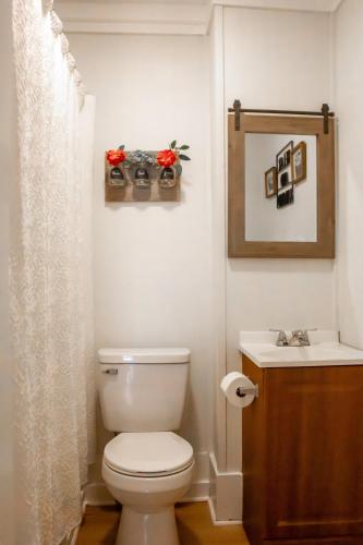 a bathroom with a toilet and a sink at Bungalow 7- Downtown, cozy, comfortable in Wilmington