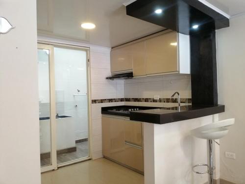 a kitchen with a black counter top and a sink at Hogar del Bosque in Nobsa