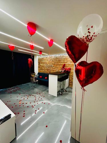 a room with red heart balloons on the floor at Art Styl in Białystok