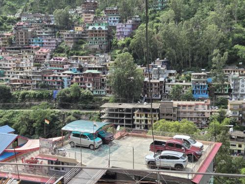 a city with trucks parked in a parking lot at MEHTA Guest House in Rāmpur