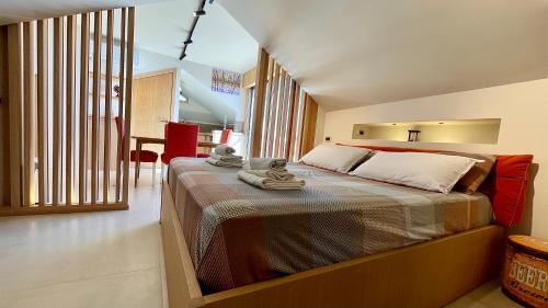 a bedroom with a bed with towels on it at "La Casa da'Mare" un attico di charme vista mare in Anzio
