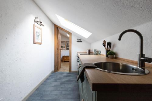 a kitchen with a sink and a counter top at Il triangolo sul Bianco degli sportivi! in Courmayeur