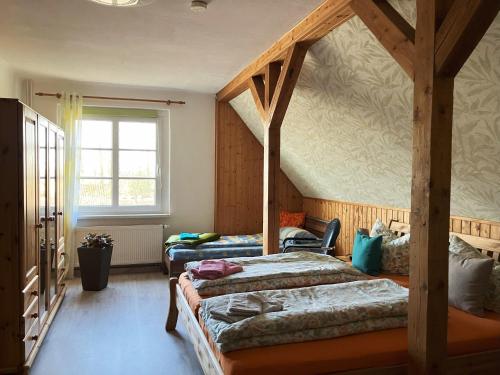 a bedroom with two beds and a window at Ferienwohnung "Tier-Garten" in Tribsees