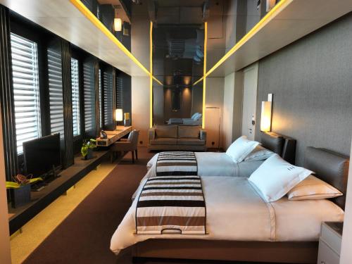 a bedroom with a large bed and a television at Key Hotel in Izmir