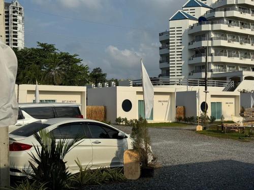 a white car parked in front of a building at Sunvada Beach Rayong in Rayong