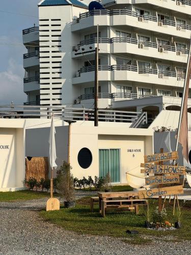 a large building with a cruise ship in the background at Sunvada Beach Rayong in Rayong