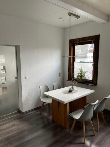 a room with a table and chairs and a window at Ferienwohnung Eisenach Meyer in Eisenach