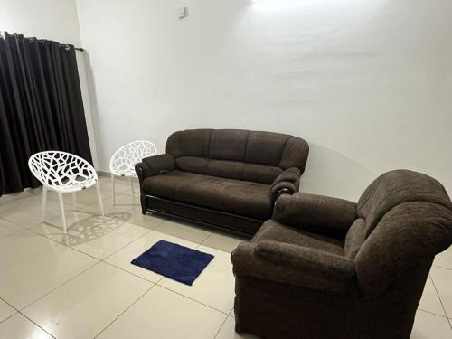 a living room with a couch and a chair at Sunrise Boutique Villa in Kozhikode