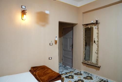 a room with a door and a mirror on the wall at People to People Siwa in Siwa