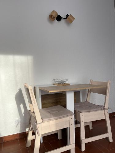une table avec deux chaises, une table et des chaises dans l'établissement Studio Gréoux-les-Bains, à Gréoux-les-Bains