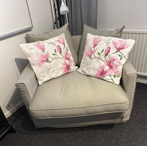 a couch with two pillows on top of it at Villan dubbelrum in Sundsvall