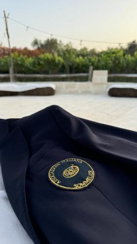 a black shirt with a badge on top of it at Masseria Messapia Wine Resort & Spa Salento in Mesagne