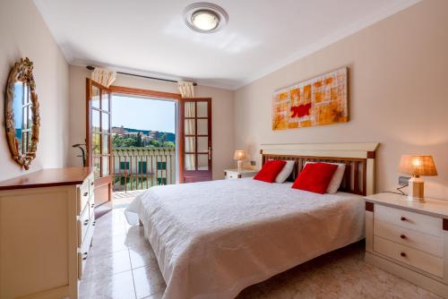 a bedroom with a bed and a large window at Apartment Sol 2 in Port de Soller