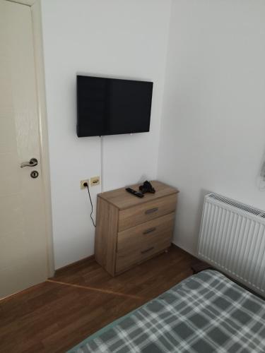 a bedroom with a bed and a flat screen tv on a wall at Salvatori in Garić