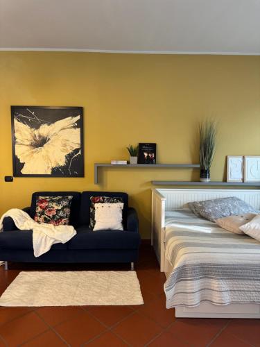 a living room with a bed and a couch at A casa di Giulia in Ponte dellʼAgrato