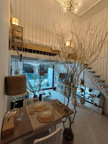 a dining room with a table and a staircase at Stylish Boutique Loft Duplex, Near Circle Mall, Balcony, Fast WiFi, 2 Pools and Gym in Dubai