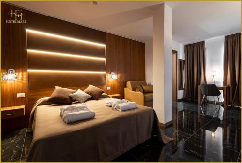 a hotel room with a bed with two pillows on it at Hotel Mare in Lignano Sabbiadoro