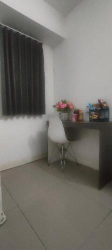 a desk with a chair in a room with a window at Sobbo Roomstay in Karawang