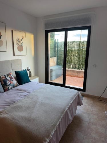 a bedroom with a bed and a large window at Apartmán se 2 ložnicemi in Isla del Fraile