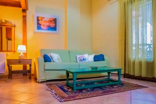 a living room with a couch and a coffee table at Dallia Loft Space in Goumenissa