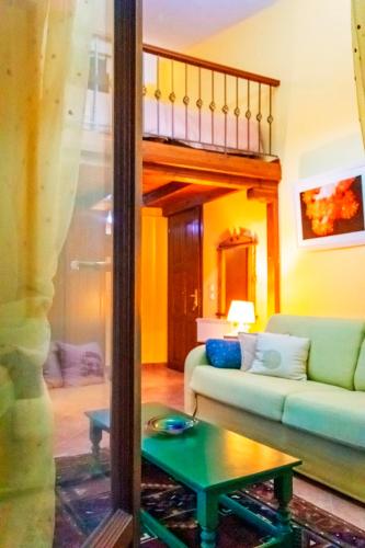 a living room with a couch and a table at Dallia Loft Space in Goumenissa