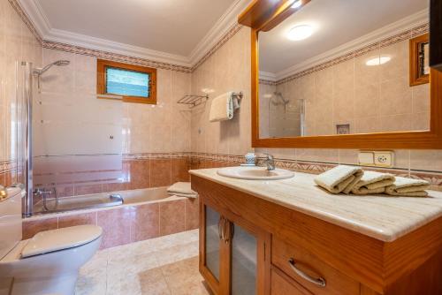 a bathroom with a sink and a toilet and a tub at Apartment Sol 2 in Port de Soller