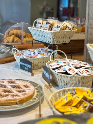 a table with baskets of pies and pastries on it at Hotel Erbaluce in Caluso