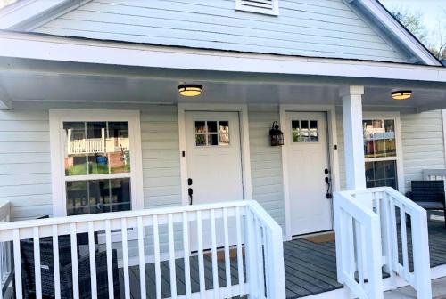 a house with white doors and a porch at Lakewoodlyon Park Renovated Cottage Near Duke 28b in Durham