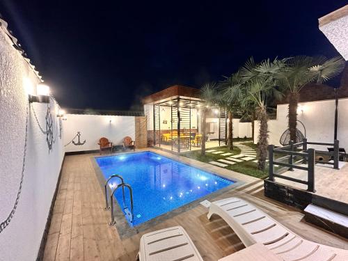 a swimming pool in the middle of a house at Qafqaz Retro Bungalow HOT POOL in Gabala