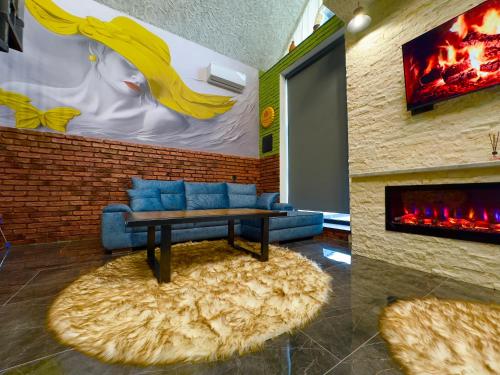 a living room with a couch and a fireplace at Qafqaz Retro Bungalow HOT POOL in Gabala