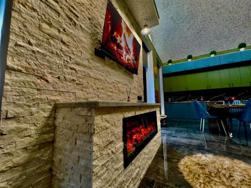 a brick wall with a fireplace in a restaurant at Qafqaz Retro Bungalow HOT POOL in Gabala