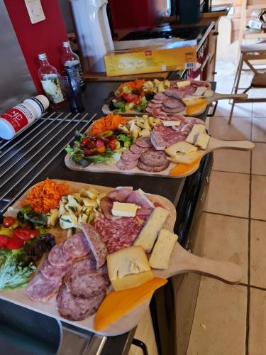 a buffet with many different types of food on plates at Gîte de Merlin l 'enchanteur in Lieuron