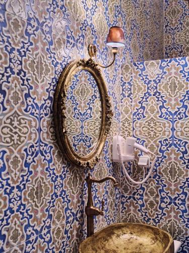 a bathroom with a sink and a mirror on a wall at Luxurious House Vasiliki with great view in Hydra