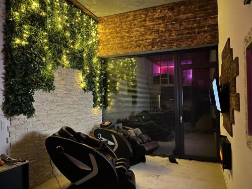 a salon with chairs and lights in a room at Appart Massage Relax - Studio in Morbier