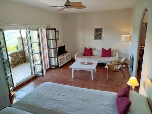 a living room with a couch and a table at Casa Montecote Eco Resort in Vejer de la Frontera