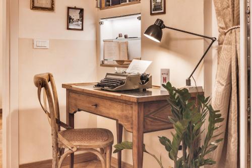 an office with a desk with a computer and a chair at Casa Saba Trieste Luxury Apartment with terrace in Trieste