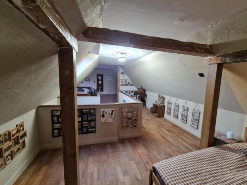a attic room with a kitchen and a bed in it at Gîte La Ferme des Délices in Epfig